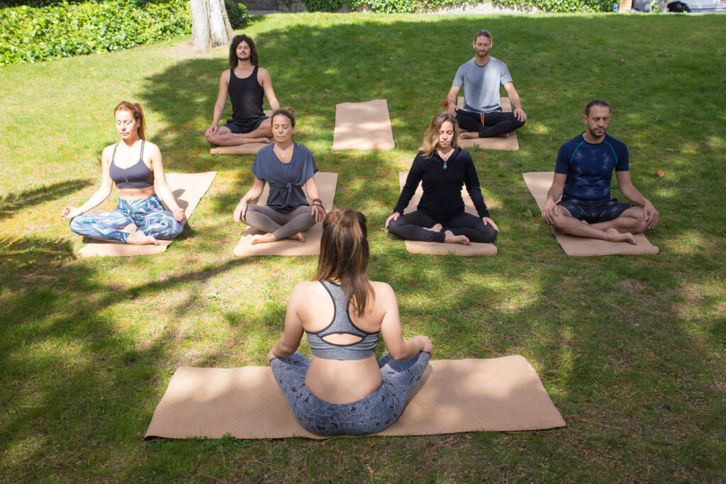 serene peaceful people meditating in park